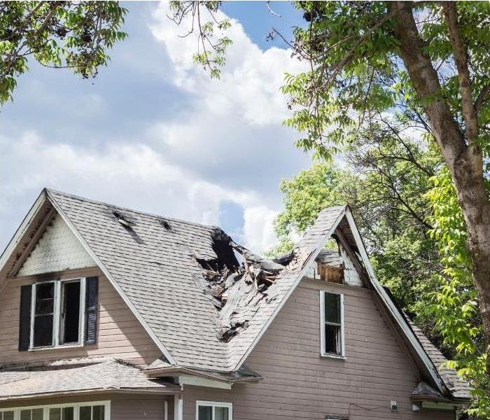 A house with damage to the roof due to a fire.
